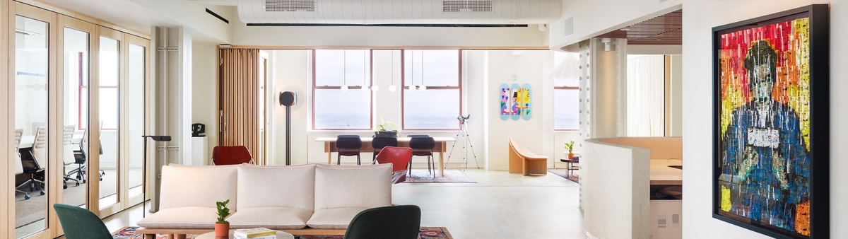 A well lit corner office overlooking a city