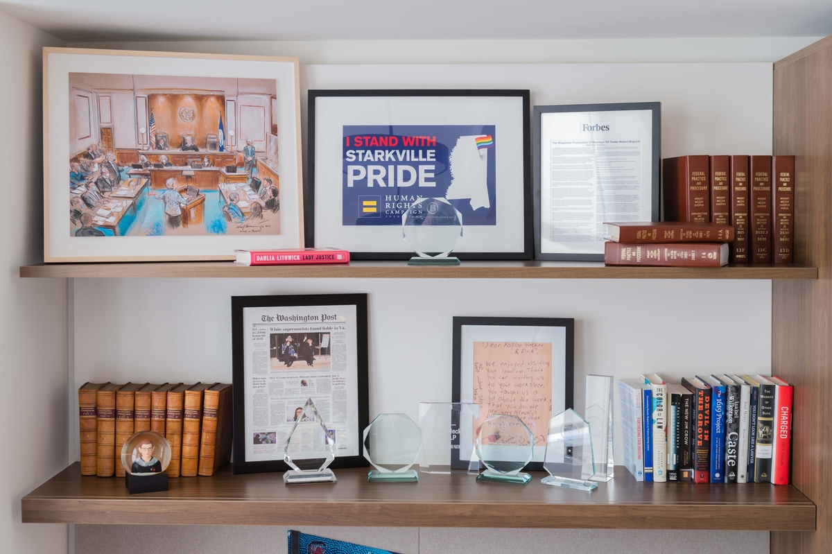 A styled bookshelf featuring a love wins, pride image.